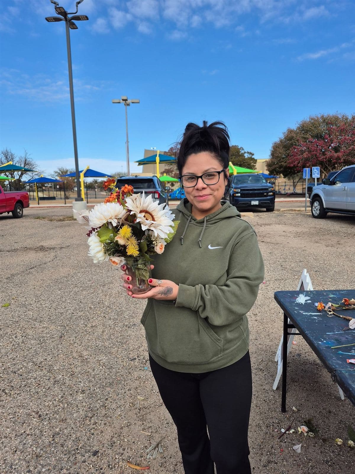 A neighbor holding her finished bouquet in a jar