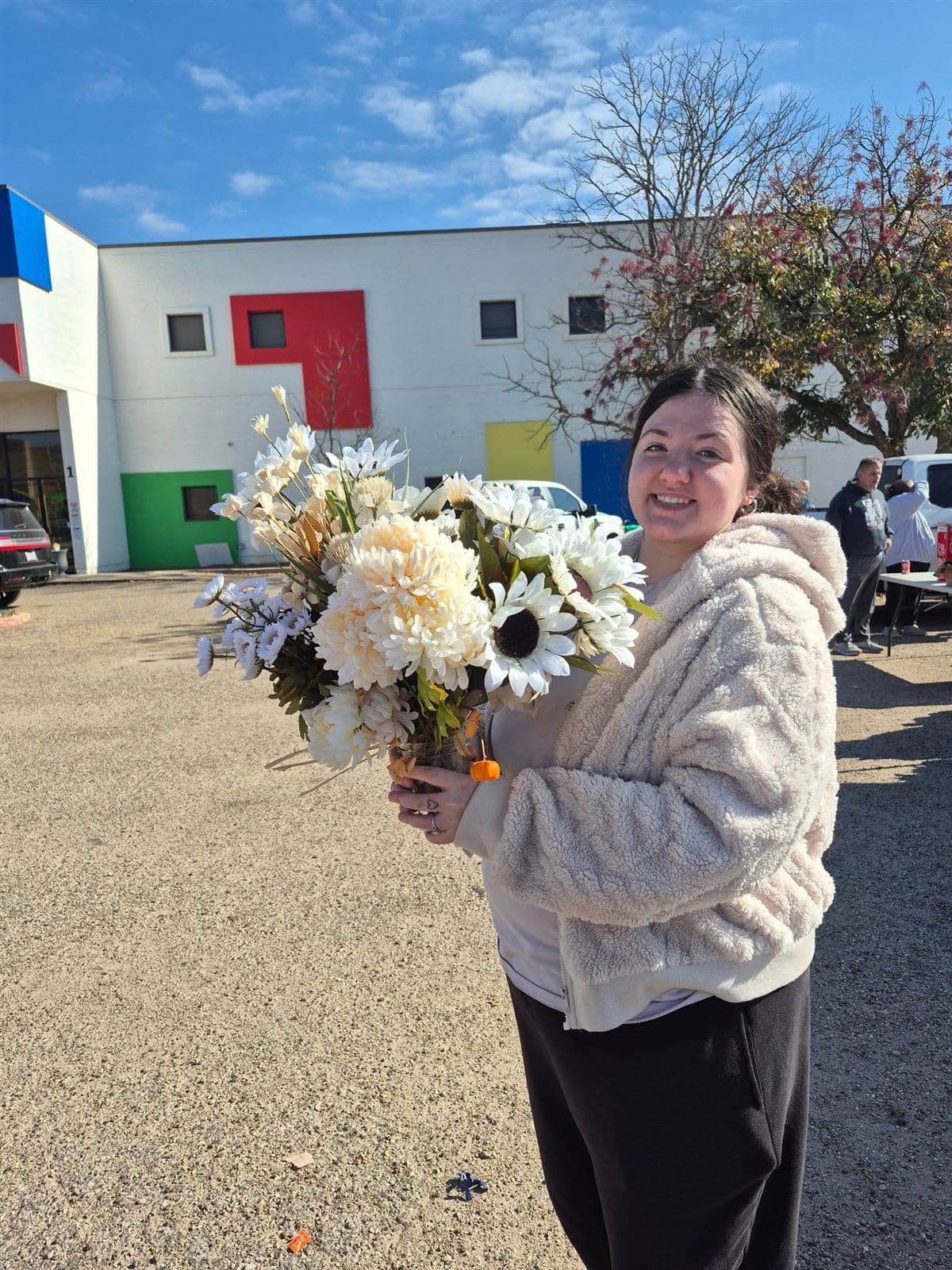 A neighbor smiling with a large white bouquet