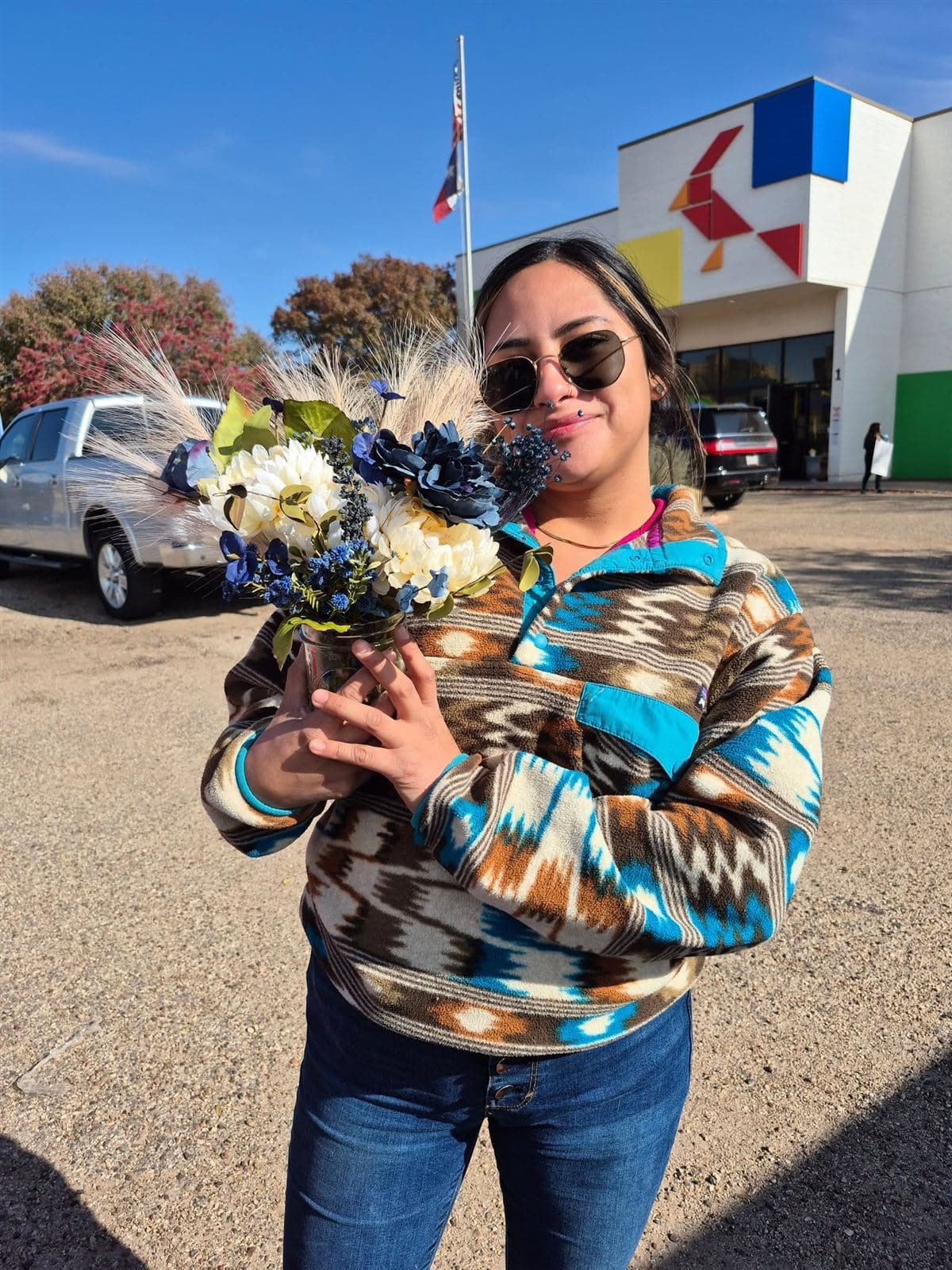 A neighbor in sunglasses with her bouquet