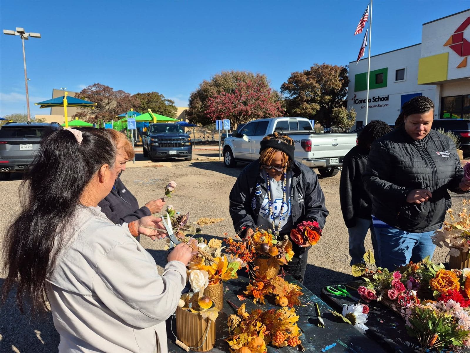 Neighbors working together at the 2025 flower table