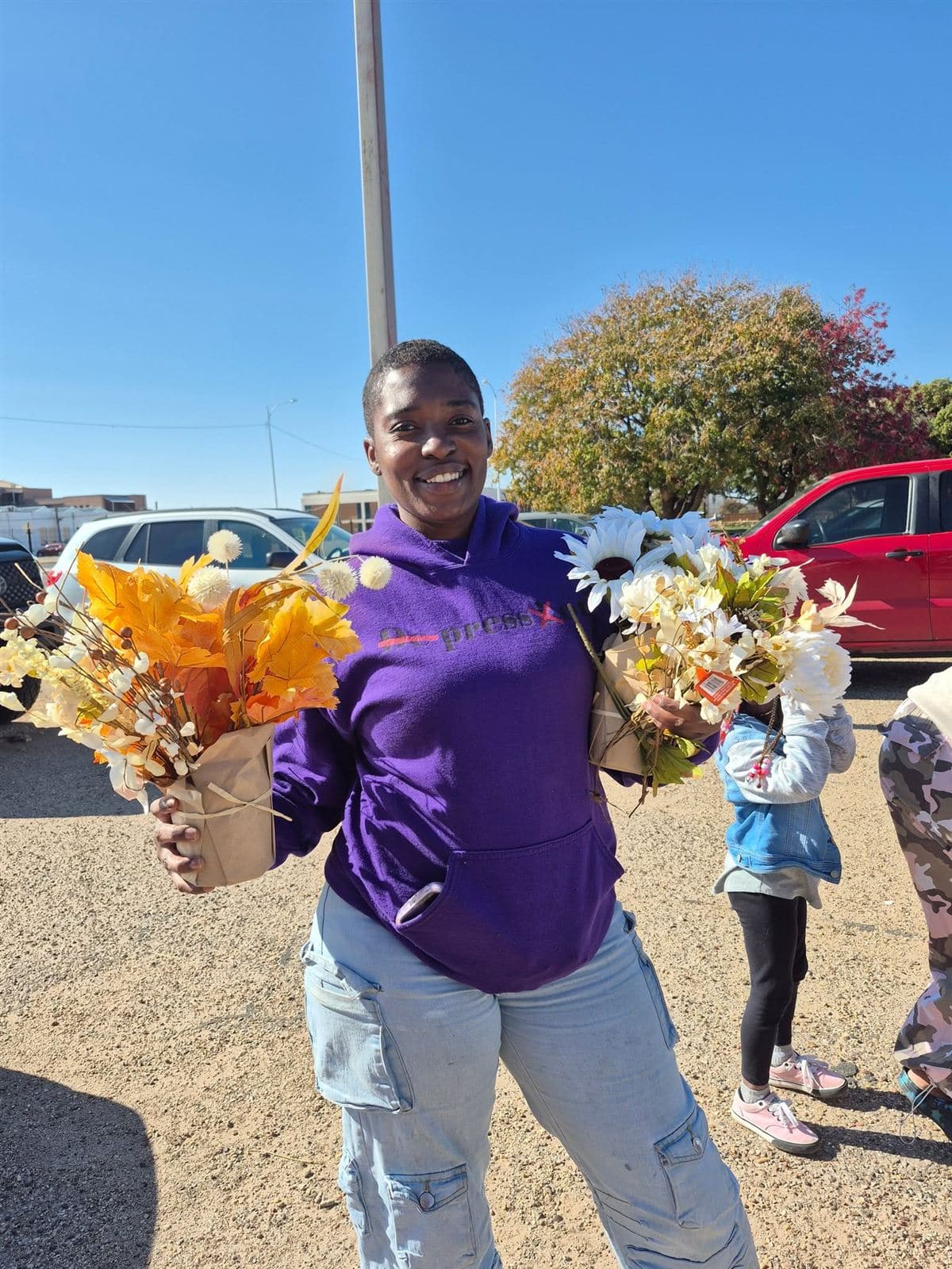 A neighbor smiling with two bouquets