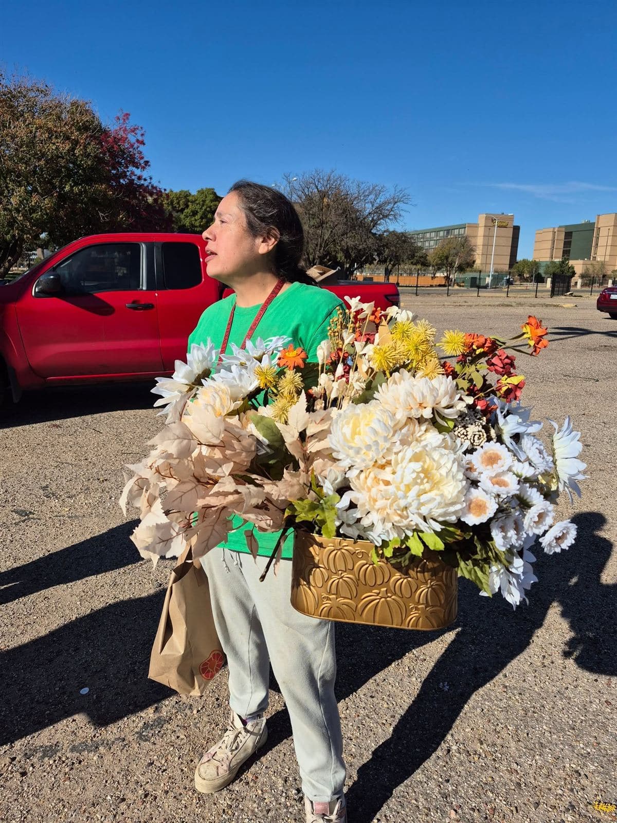 A neighbor carrying a large arrangement